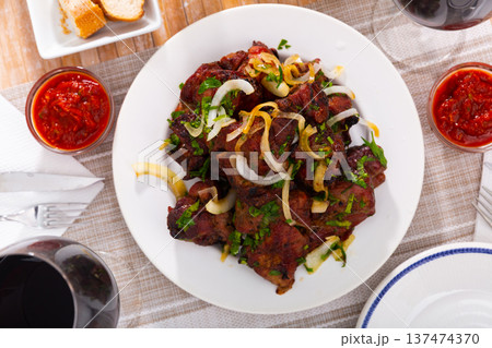 Pork shashlik with onion, greenery and glasses of wine Pork shashlik with onion, greenery and glasses of wine 137474370
