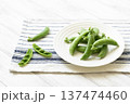 白皿に乗せたスナップエンドウと割ったさや 137474460