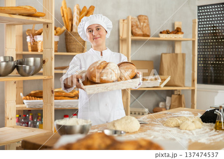 Teen girl holding bread in square wicker basket 137474537
