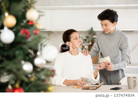 Boy asking mother for money 137474934