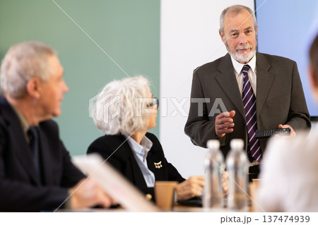 Elderly man presenting with remote control Elderly man presenting with remote control 137474939