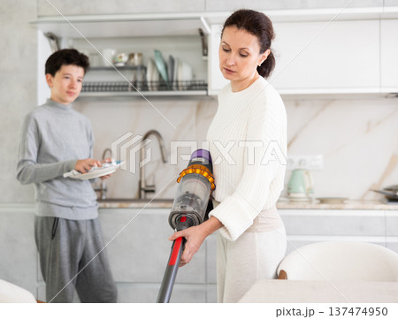 Mother and son doing household chores Mother and son doing household chores 137474950