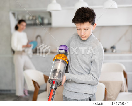 Son doing household chores Son doing household chores 137475084