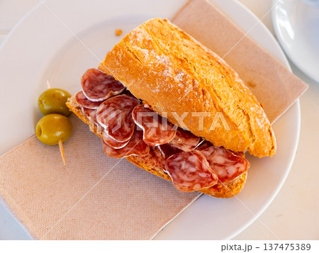 Sandwich with delicious delicaty dried sausage Fuet 137475389
