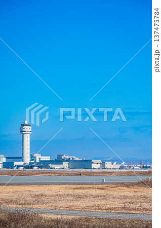 青空の下を飛ぶ飛行機と新千歳空港の風景（北海道千歳市） 137475784