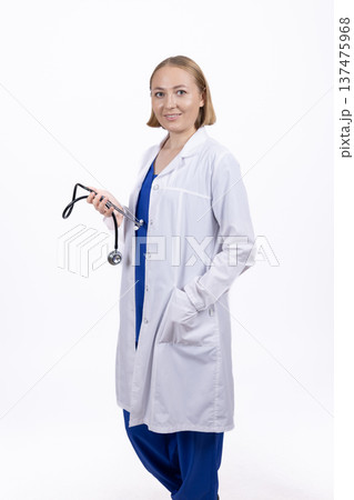 Female doctor standing with stethoscope in professional studio Female doctor standing with stethoscope in professional studio 137475968