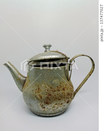 Antique cast iron teapot on a white background, close-up. Antique cast iron teapot on a white background, close-up. 137477027