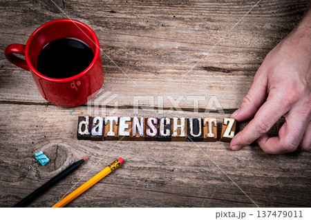 Data Protection Concept With German Word DATENSCHUTZ on Wooden Workspace 137479011