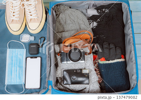 top view with protective mask and accessories prepare in luggage for travel with new normal style for winter season top view with protective mask and accessories prepare in luggage for travel with new normal style for winter season 137479082