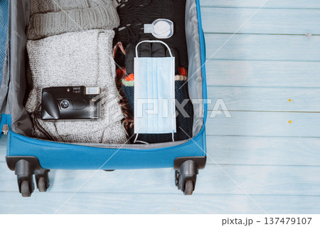 top view with protective mask and accessories prepare in luggage for travel with new normal style for winter season 137479107
