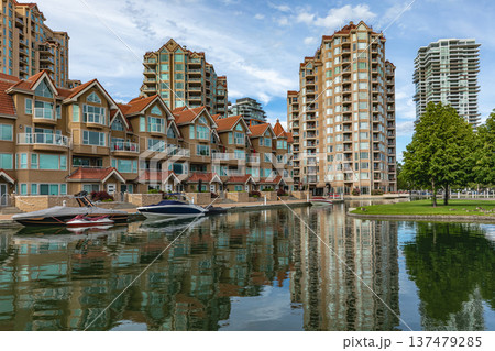Facade of a modern luxury hotel. Resort Waterfront park and residential area in a city 137479285