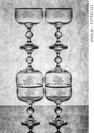 Still life with glassware on a reflective surface 137482122