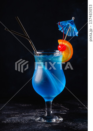 Glass of blue lagoon cocktail decorated with orange and cherry Glass of blue lagoon cocktail decorated with orange and cherry 137483053