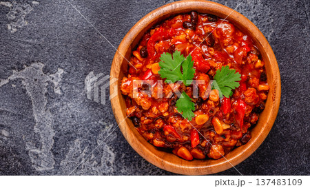 Chili Con Carne in bowl on dark background. Chili Con Carne in bowl on dark background. 137483109