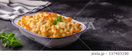 American mac and cheese, macaroni pasta in cheesy sauce American mac and cheese, macaroni pasta in cheesy sauce 137483190