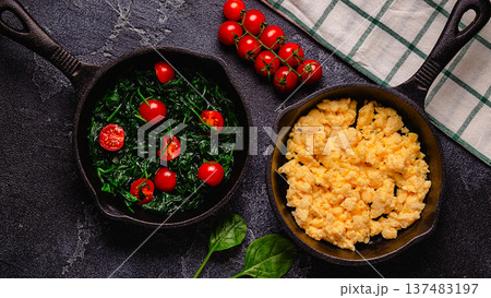 Cooked omelet and spinach with tomatoes in pans Cooked omelet and spinach with tomatoes in pans 137483197
