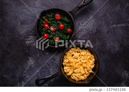 Cooked omelet and spinach with tomatoes in pans Cooked omelet and spinach with tomatoes in pans 137483198
