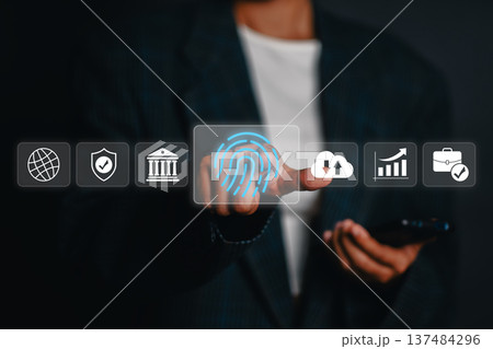 A person in a suit using a digital fingerprint scanner for secure online access, symbolizing modern technology and data protection. 137484296