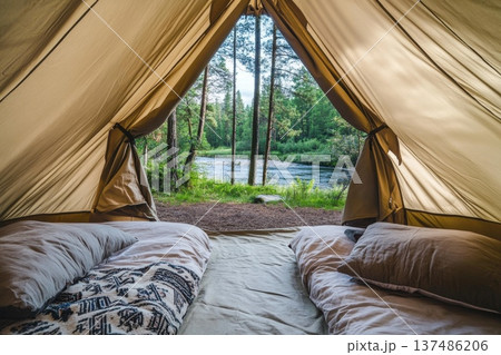 Cozy Tent Interior View During Golden Hour with River and Nature in Background 137486206