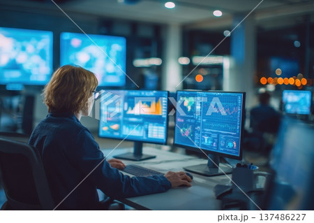 Financial Analyst Reviewing Predictive AI Graphs in Modern Office Environment 137486227