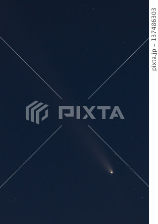 Comet with glowing tail moving through dark space 137486303