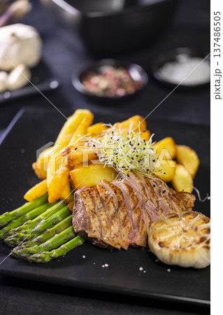 Roasted duck breast with asparagus and fried potatoes Roasted duck breast with asparagus and fried potatoes 137486505