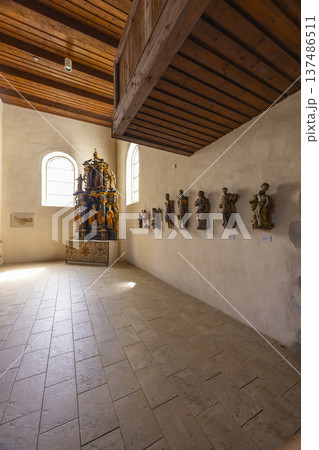 Church interior with ancient wooden statues and altar in Pribylina 137486511