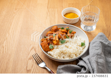 Chicken tikka masala curry with rice on wooden background Chicken tikka masala curry with rice on wooden background 137486631