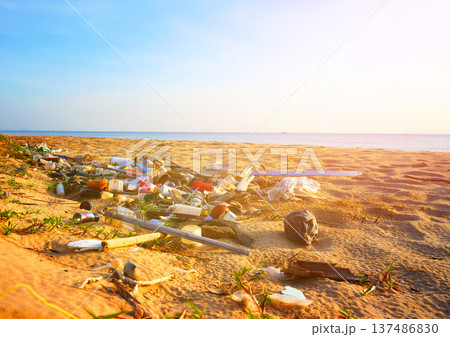 Trash on beach at sea. Garbage dump at ocean. Trash, debris on sea beach. Littered shore. Trash on beach at sea. Garbage dump at ocean. Trash, debris on sea beach. Littered shore. 137486830