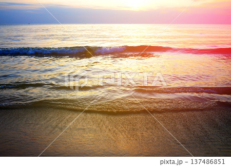 Waves at sea on dramatic sunset background. Sea waves at beach. Waves on sea in calm weather. Waves at sea on dramatic sunset background. Sea waves at beach. Waves on sea in calm weather. 137486851