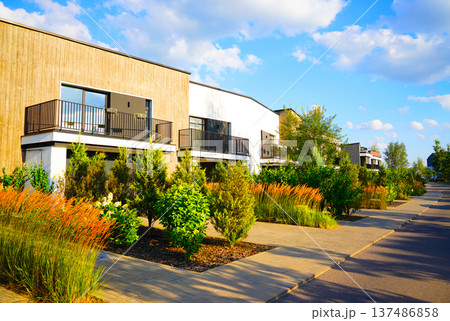Modern Residential Area With Lush Landscaping at townhouse. Residential neighborhood Modern Residential Area With Lush Landscaping at townhouse. Residential neighborhood 137486858
