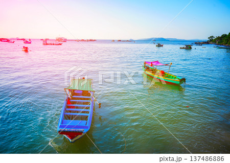 Fishing boats at shore on sunrise. Fishermen's boats in sea at  shore in fishing village  137486886