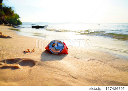 Crumpled soda can on sand beach at sea. Discarded broken soda can at seashore. Crumpled soda can on sand beach at sea. Discarded broken soda can at seashore. 137486895