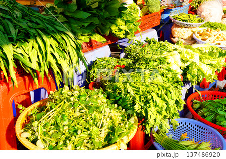 Vegetables market. Vendors display various types of fresh vegetables in baskets for sale Vegetables market. Vendors display various types of fresh vegetables in baskets for sale 137486920