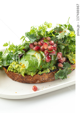 Avocado toast with cucumber herbs and pomegranate Avocado toast with cucumber herbs and pomegranate 137486987