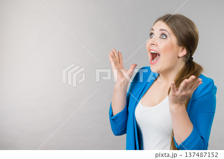 Shocked amazed woman gesturing with hands Shocked amazed woman gesturing with hands 137487152