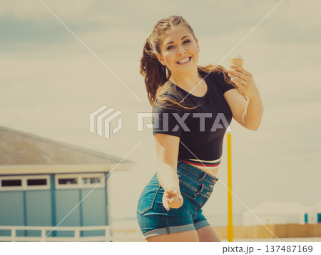 Young woman eating ice cream Young woman eating ice cream 137487169