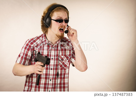 Gamer man shooting from gun Gamer man shooting from gun 137487383