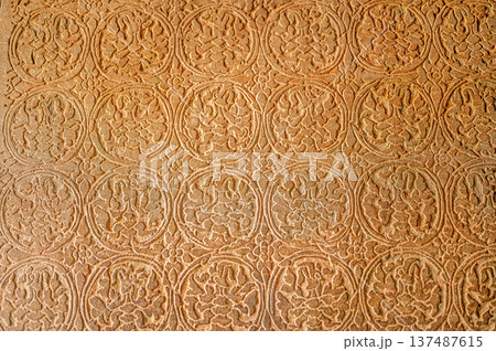 Abstract stone carving geometric floral pattern ancient temple wall texture bas relief detailed craft historic art background design architecture religion symbol weathered 137487615
