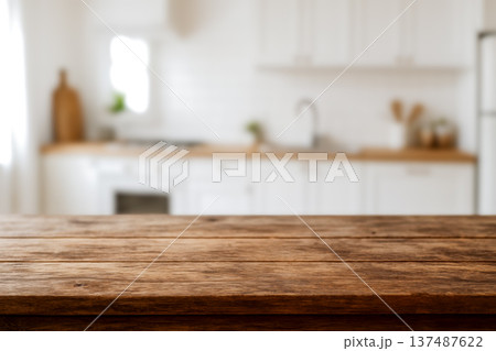 Empty wooden table with blurred kitchen background, rustic surface for food product display, advertising, cooking presentations, modern healthy meal preparation visuals 137487622