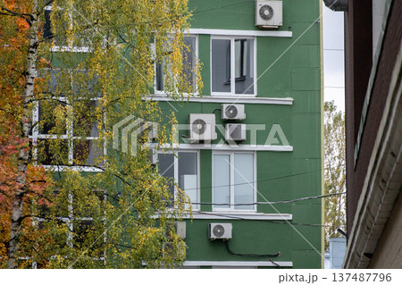 air conditioning on facade of building, air cooling in hot weather. air conditioning on facade of building, air cooling in hot weather. 137487796