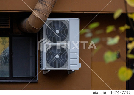 air conditioning on facade of building, air cooling in hot weather. air conditioning on facade of building, air cooling in hot weather. 137487797