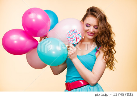 Woman with colorful balloons and lollipop Woman with colorful balloons and lollipop 137487832