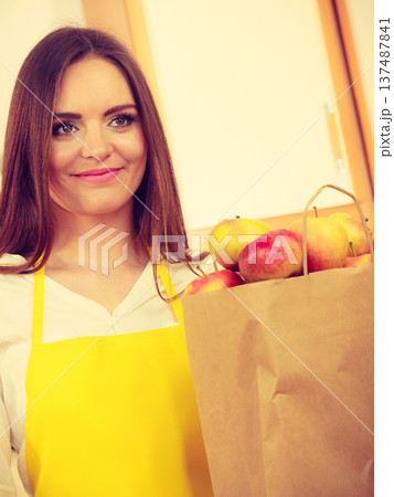 Woman housewife in kitchen with many fruits 137487841