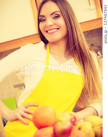 Female cook working in kitchen. Female cook working in kitchen. 137487842