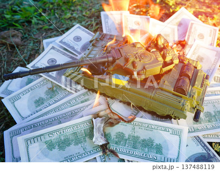 Battle tank on US dollar banknotes during burning. War costs, military spending. Money laundering  137488119