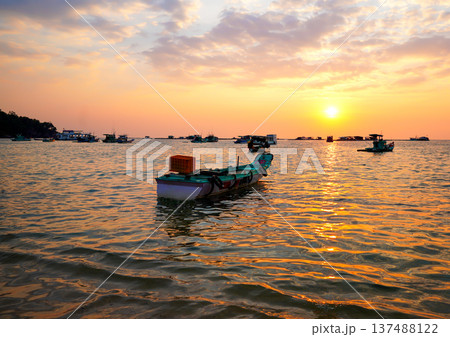 Fishing boats at shore on sunset. Fishermen's boats in sea at shore in fishing village Fishing boats at shore on sunset. Fishermen's boats in sea at shore in fishing village 137488122