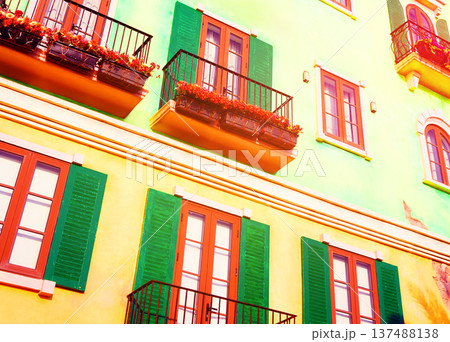 Green facade building with flower in boxes on balcony during daytime. Colorful building  137488138