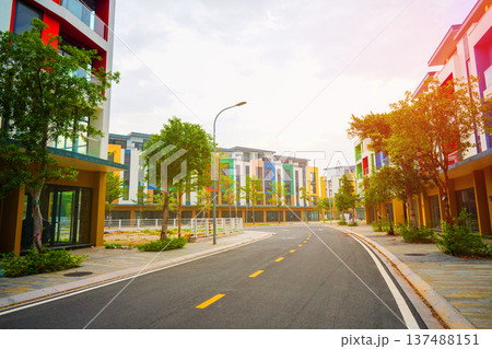 Road curves through modern buildings with colorful facades in new resort area in island Phu Quoc 137488151