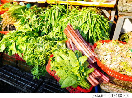 Vegetables for sale at local market. Vendors display various types of fresh vegetables Vegetables for sale at local market. Vendors display various types of fresh vegetables 137488168